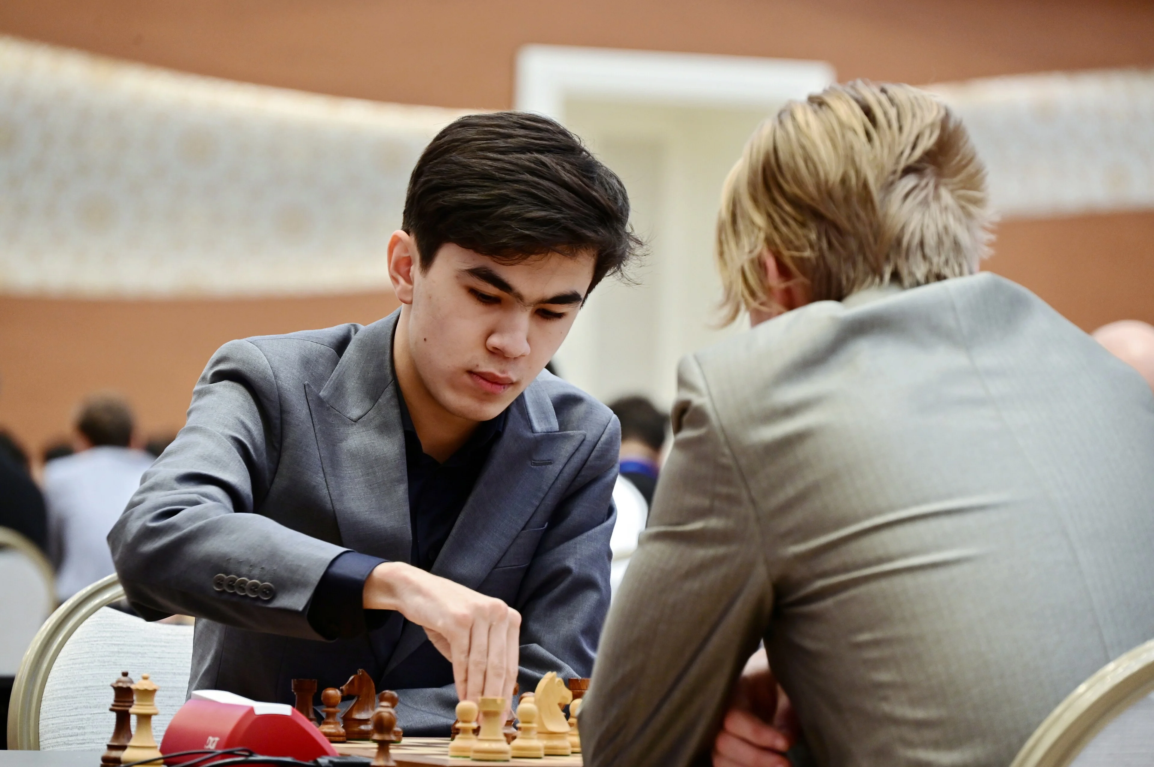 Javokhir Sindarov making a move during a tournament game