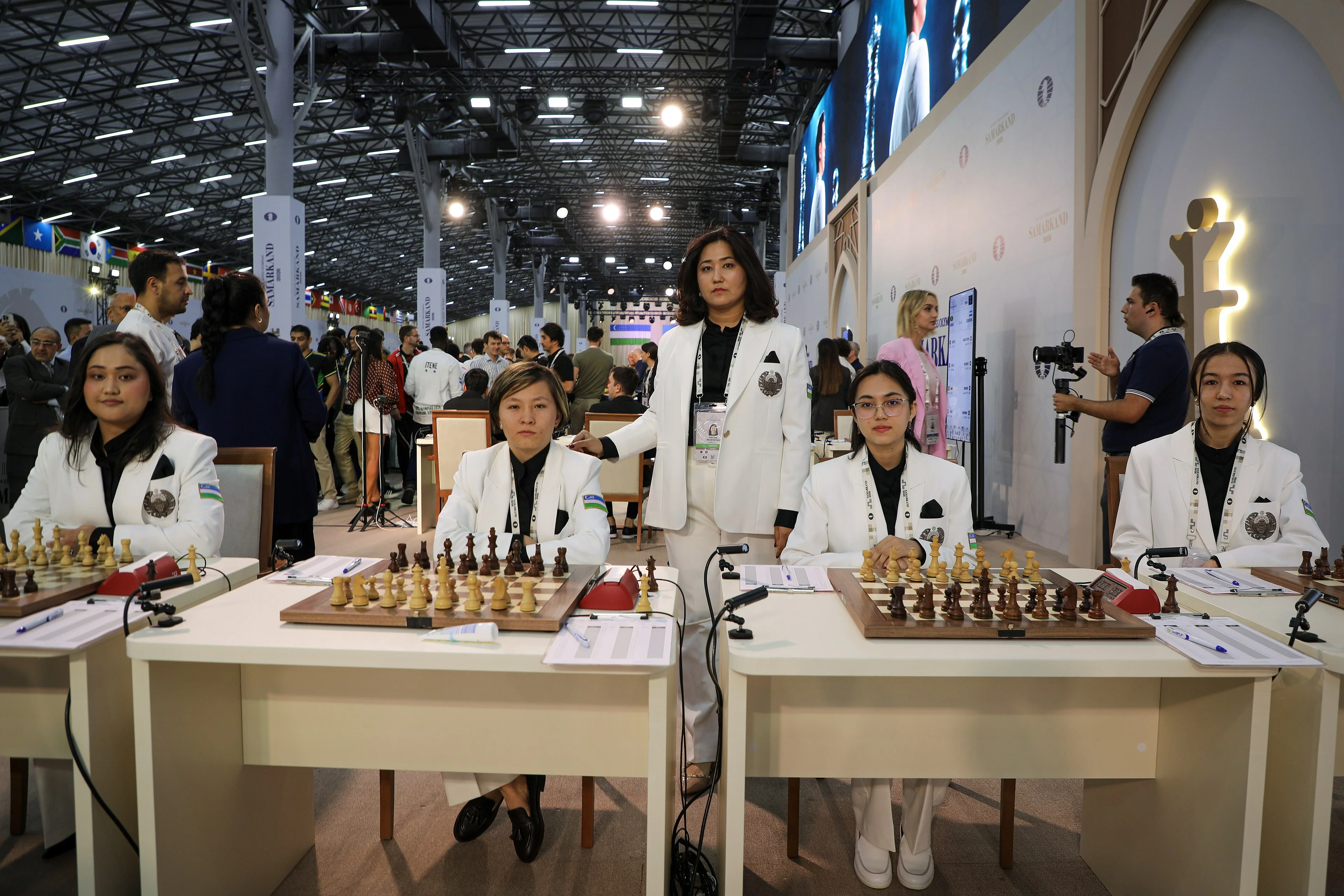 The Uzbekistan women's team seated at their boards at the 46th Chess Olympiad in Samarkand